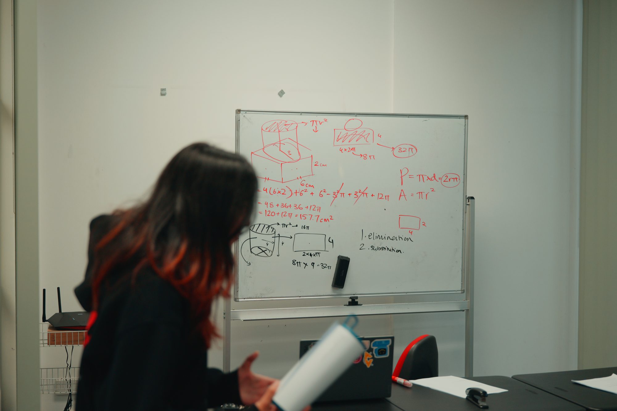 A Spartan Tuition tutor working through a problem on the whiteboard