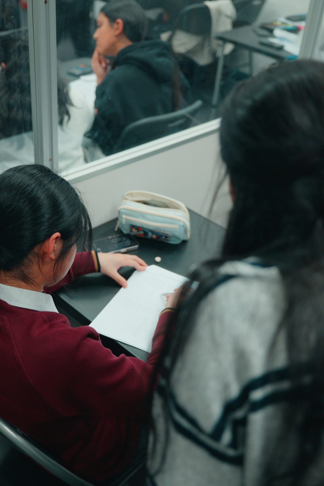 Two students working through practice questions in a Spartan Tuition class