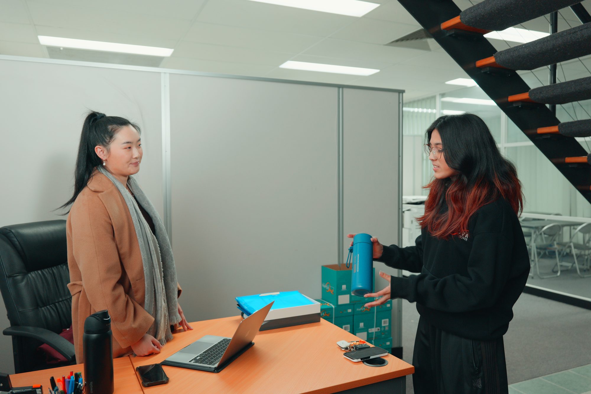 Two Spartan Tuition tutors talking in the Mount Waverley office